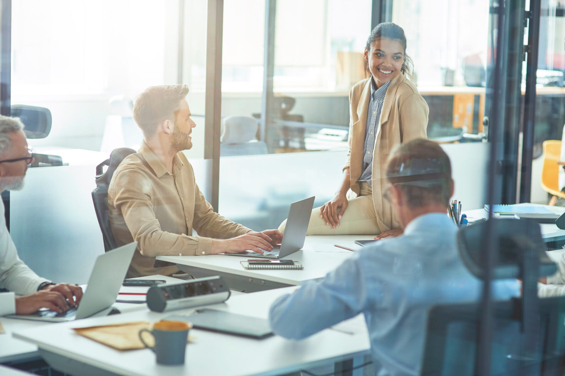 An office worker discussing something with colleagues while sitting in board room
