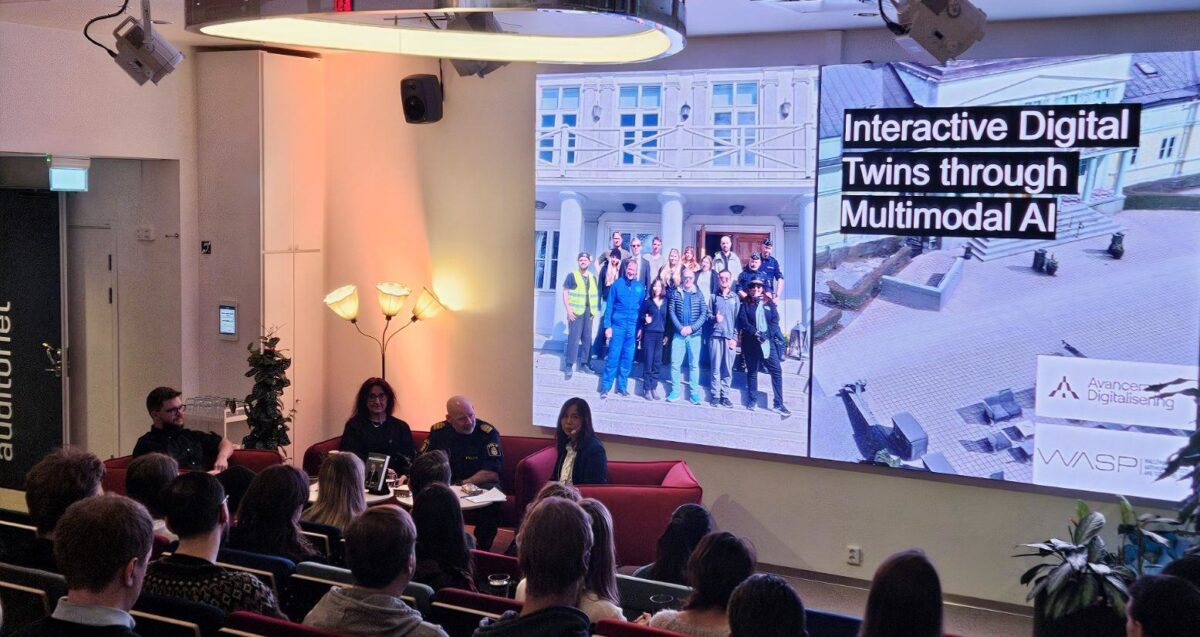 people sitting in an auditorium, facing a screen with a presentation